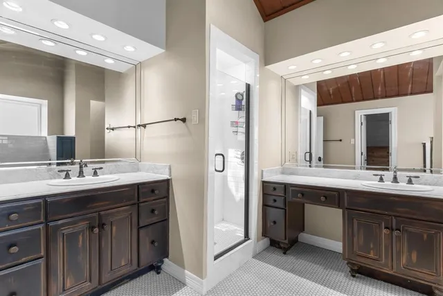 a bathroom with a double vanity sink and mirror