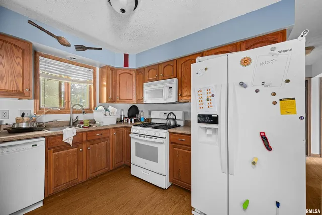 a kitchen with stainless steel appliances a refrigerator sink and white cabinets