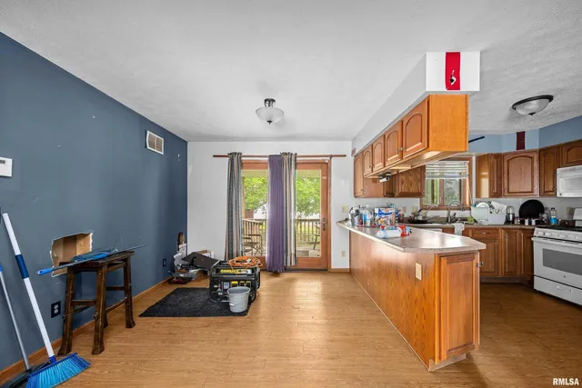 a living room with furniture a flat screen tv and next to a window