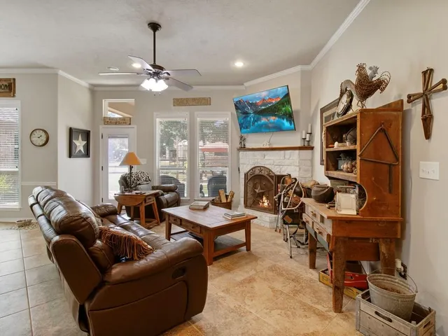 a living room with furniture a fireplace and a flat screen tv