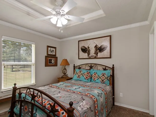 a bedroom with a bed and a painting on the wall