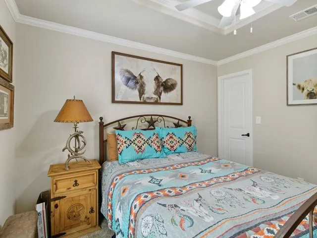 a bedroom with a bed and a painting on the wall