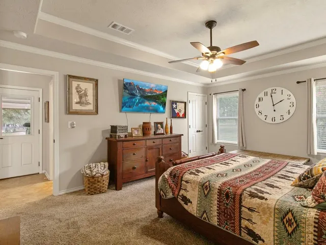 a bedroom with a bed and a chandelier