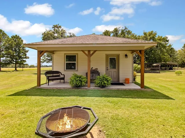 a view of a house with swimming pool and a garden