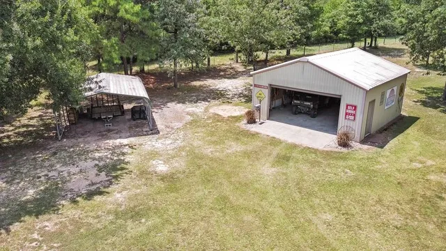 a backyard of a house with table and chairs