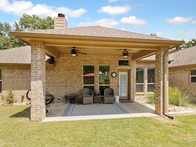 a view of a house with backyard porch and sitting area