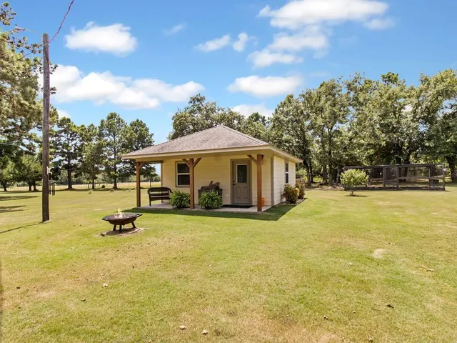 a swimming pool with outdoor seating and yard