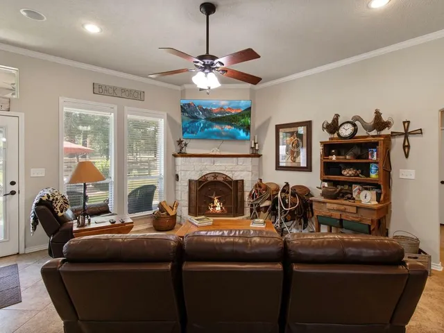a living room with furniture a fireplace and a chandelier