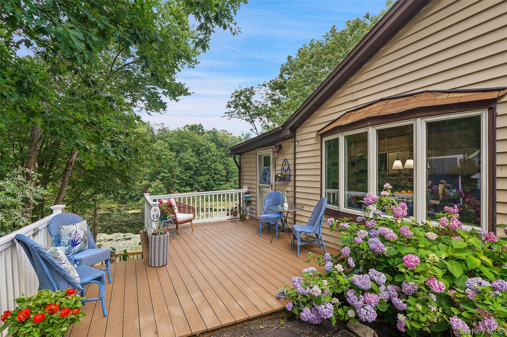 18 Sylvan Road Lake Peekskill, NY 10537 - Photo 2 of 50 Composite decking welcomes you to sit and sip and enjoy the surrounding sounds of nature