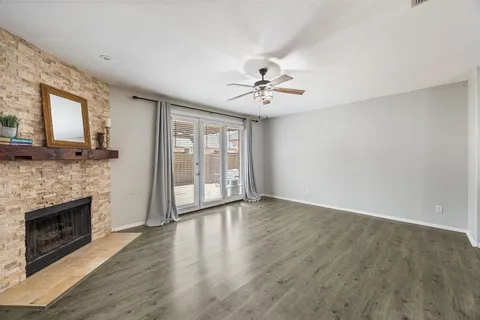 a view of an empty room with a fireplace and a window