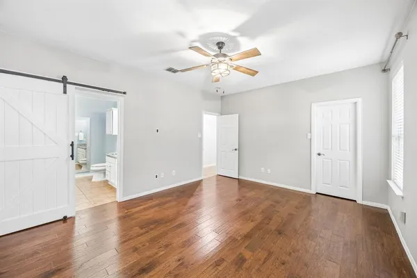a view of an empty room with wooden floor