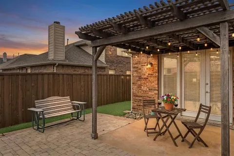 a patio with a table and chairs