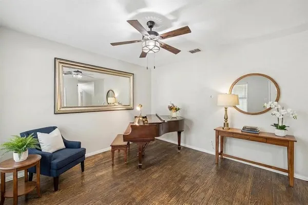 a living room with furniture and a wooden floor
