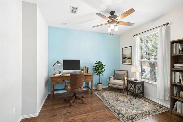 a workspace with wooden floor and a rug
