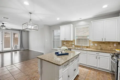 a kitchen with stainless steel appliances granite countertop a sink stove and cabinets