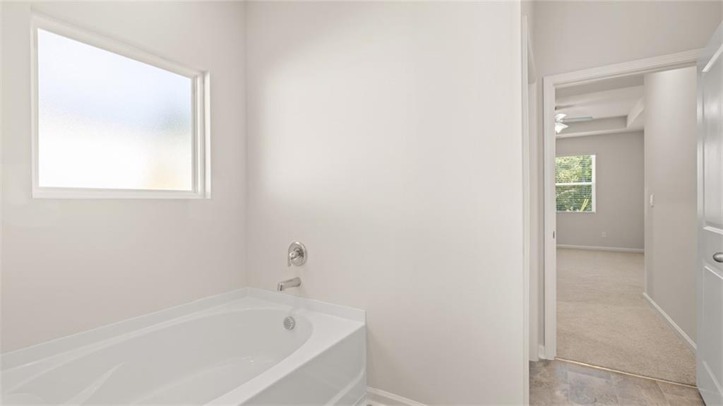216 Cattle Drive Perry, GA 31069 - Photo 22 of 32 a white bath tub sitting next to a window