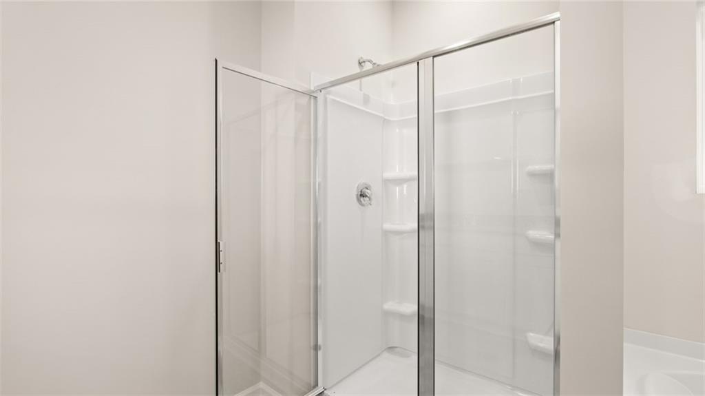 216 Cattle Drive Perry, GA 31069 - Photo 23 of 32 a bathroom with a glass shower door