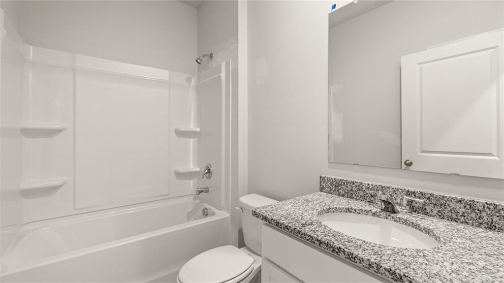 216 Cattle Drive Perry, GA 31069 - Photo 28 of 32 a bathroom with a granite countertop sink toilet and shower