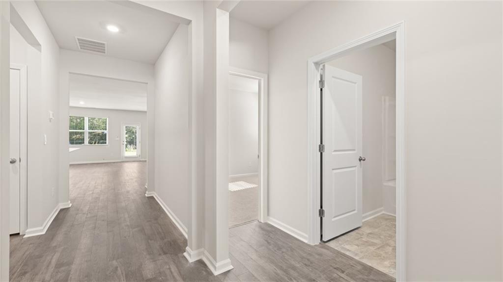 216 Cattle Drive Perry, GA 31069 - Photo 4 of 32 a view of a hallway with wooden floor and closet