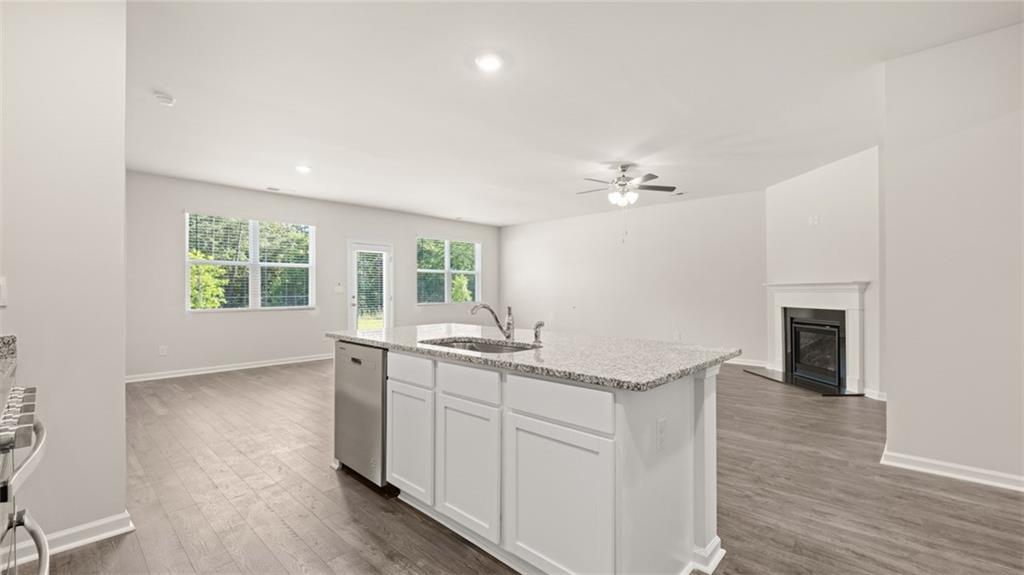 216 Cattle Drive Perry, GA 31069 - Photo 9 of 32 a kitchen with granite countertop a stove a sink and a chandelier