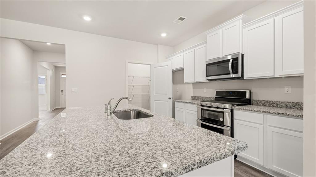 216 Cattle Drive Perry, GA 31069 - Photo 10 of 32 a kitchen with granite countertop a sink and steel appliances