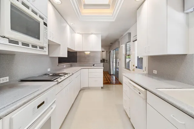 a kitchen with stainless steel appliances sink a microwave and cabinets