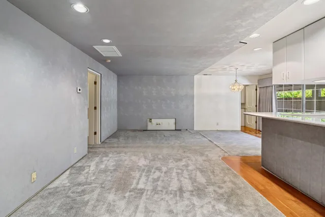 a view of a hallway with wooden floor and fence