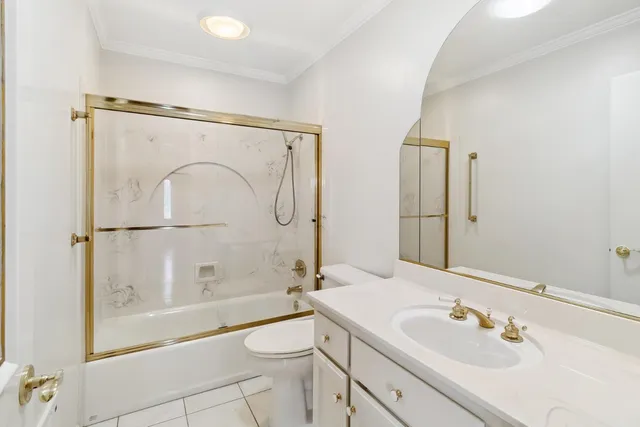 a living room with furniture potted plant and a large window