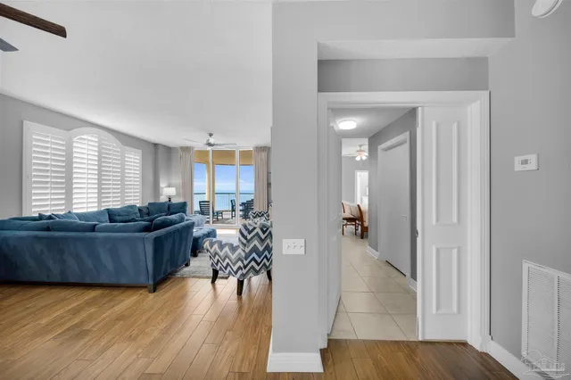 a living room with furniture and a wooden floor