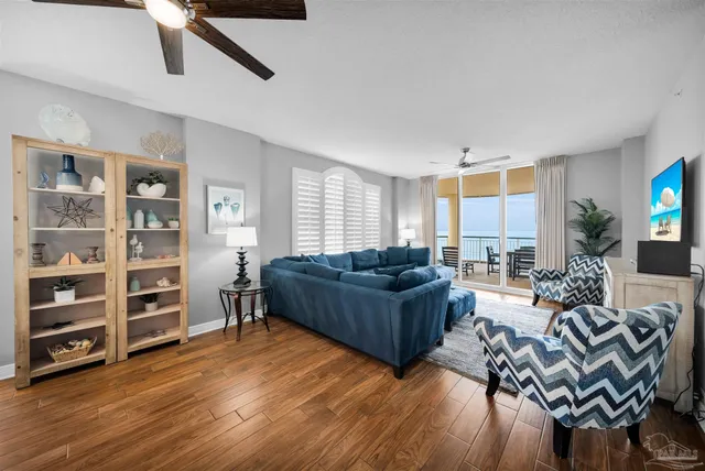 a living room with furniture and a wooden floor
