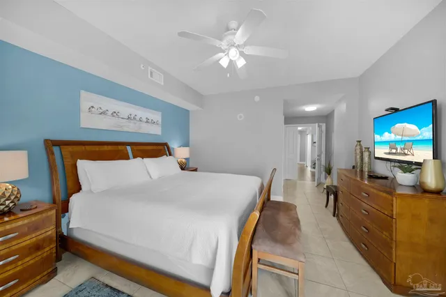 a bed room with a bed and a television