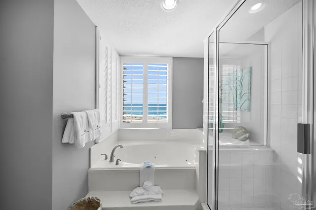 a bathroom with a bathtub and a shower