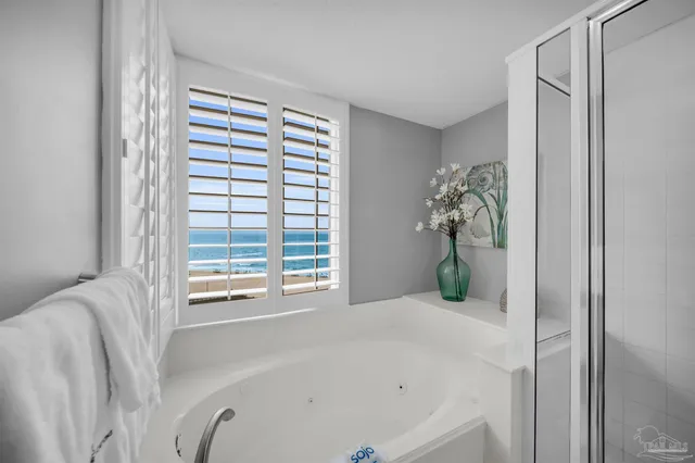 a white bath tub sitting in a bathroom next to a window
