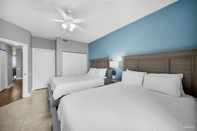 a bedroom with a large bed and a chandelier