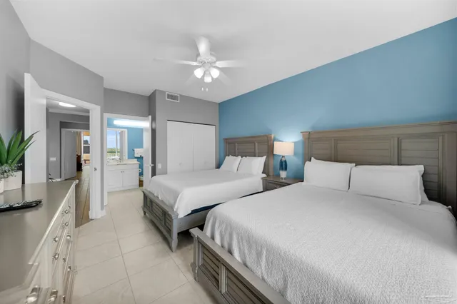 a bedroom with two beds and a chandelier