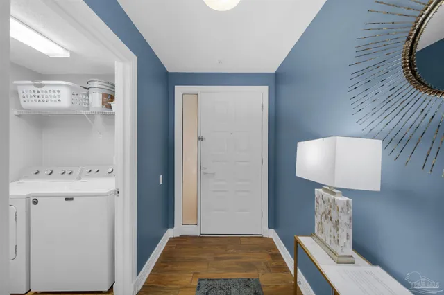 a hallway with painting and stairs