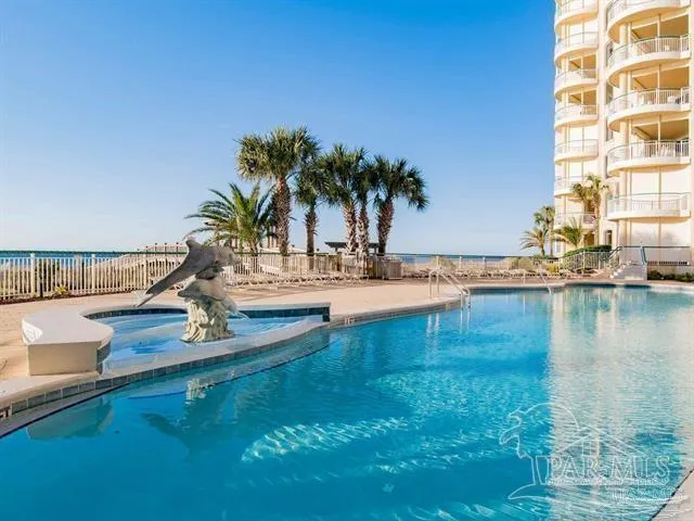 a swimming pool with outdoor seating and yard