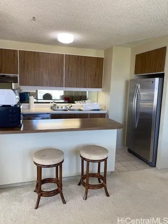 a kitchen with kitchen island a counter top space appliances and cabinets