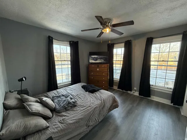 a bedroom with a large bed and a window