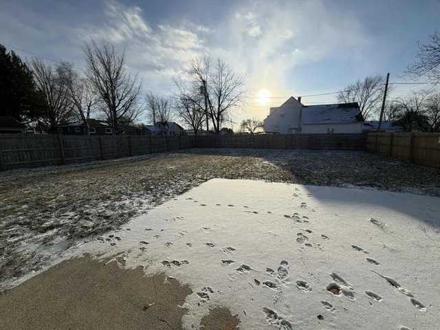 a view of wooden fence and trees