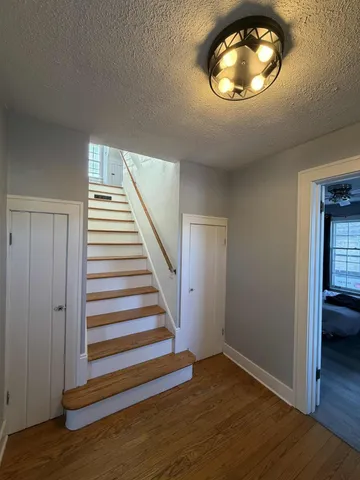 a view of an entryway with wooden floor