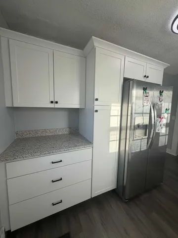 a kitchen with stainless steel appliances a refrigerator and cabinets
