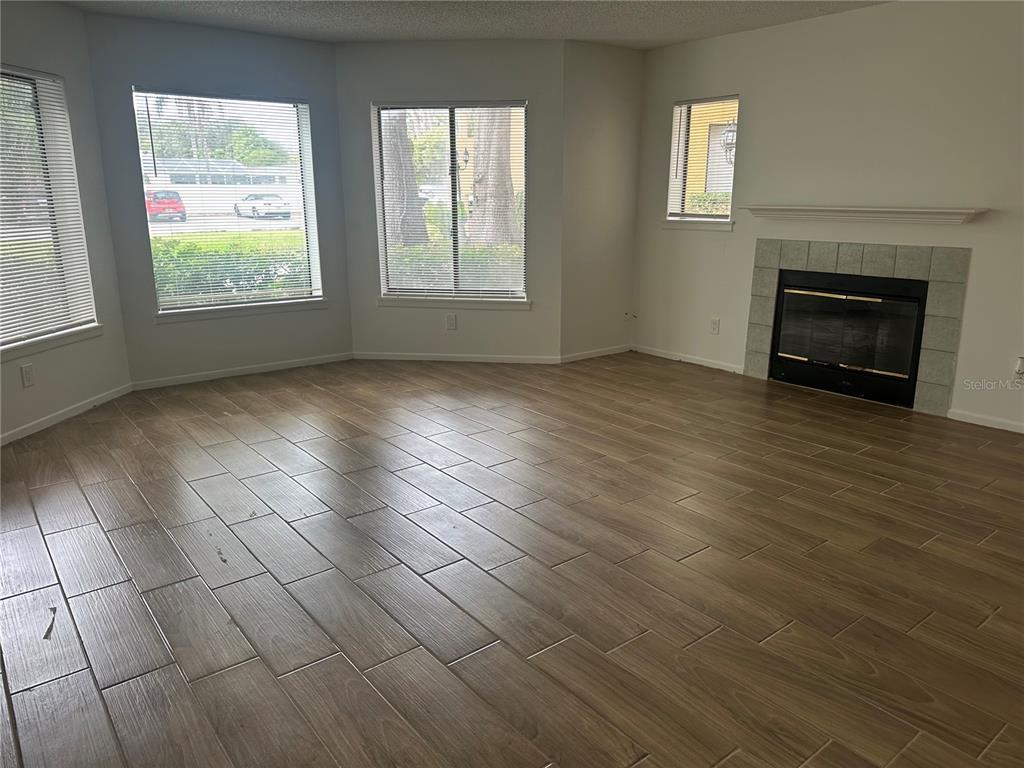 1550 South Belcher Road, Unit 412 Clearwater, FL 33764 - Photo 11 of 40 an empty room with windows and fireplace