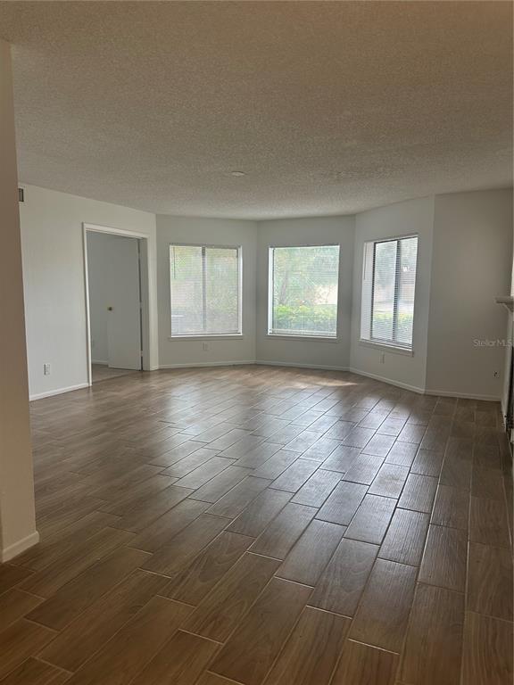 1550 South Belcher Road, Unit 412 Clearwater, FL 33764 - Photo 12 of 40 an empty room with wooden floor and windows