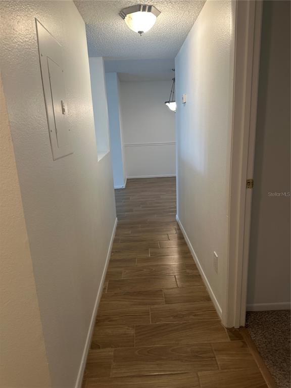 1550 South Belcher Road, Unit 412 Clearwater, FL 33764 - Photo 14 of 40 a view of a hallway with wooden floor and entryway