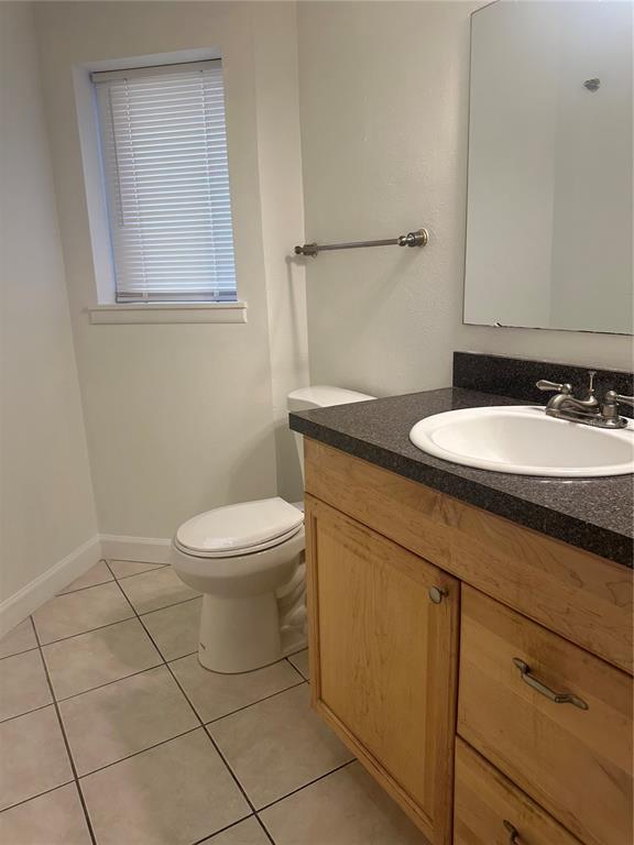1550 South Belcher Road, Unit 412 Clearwater, FL 33764 - Photo 18 of 40 a bathroom with a granite countertop toilet sink and mirror