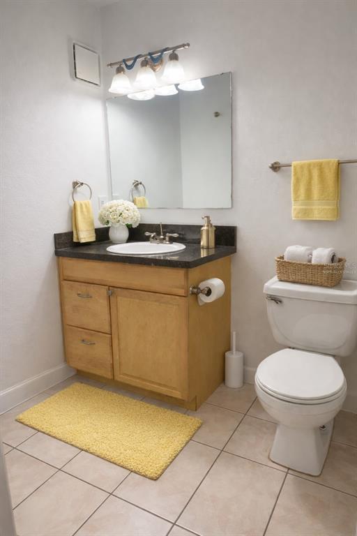 1550 South Belcher Road, Unit 412 Clearwater, FL 33764 - Photo 22 of 40 a bathroom with a sink a toilet and a mirror