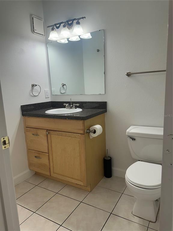 1550 South Belcher Road, Unit 412 Clearwater, FL 33764 - Photo 24 of 40 a bathroom with a granite countertop toilet sink and mirror