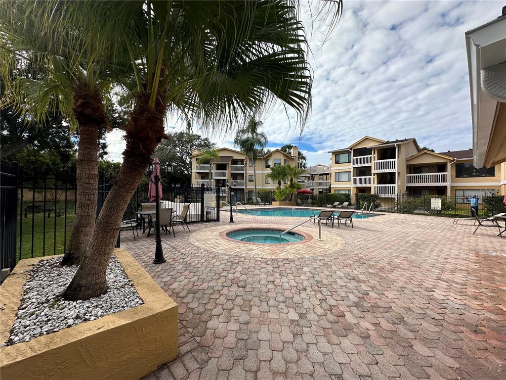 1550 South Belcher Road, Unit 412 Clearwater, FL 33764 - Photo 35 of 40 a swimming pool with outdoor seating and yard