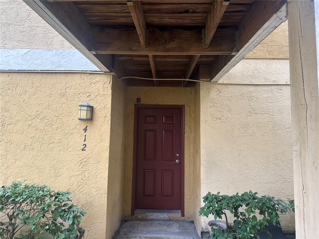 1550 South Belcher Road, Unit 412 Clearwater, FL 33764 - Photo 4 of 40 a view of a hallway with wooden door